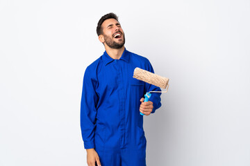 Canvas Print - Painter man holding a paint roller isolated on white background laughing