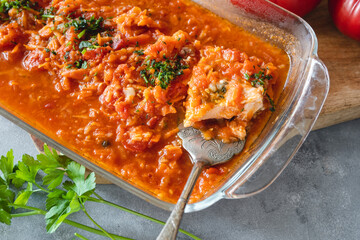 Wall Mural - Trout in tomato sauce with vegetables, garnished with parsley