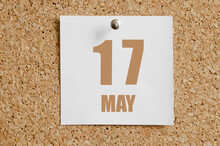 May 17. 17th Day Of The Month, Calendar Date. White Calendar Sheet Attached To Brown Cork Board.Spring Month, Day Of The Year Concept