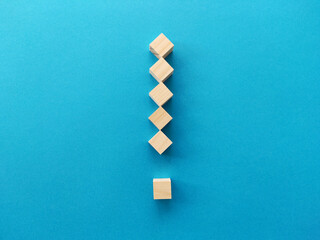 Wall Mural - Exclamation mark with wooden blocks on blue background