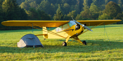 Wall Mural - Under canvas under the wing or camping by plane