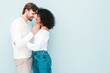 © halayalex - Smiling beautiful woman and her handsome boyfriend. Happy cheerful multiracial family having tender moments on grey background  in studio. Multiethnic models hugging. Embracing each other.Love concept
