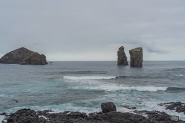 Wall Mural - Mosteiros beach, volcanic sand beach in Sao Miguel, Azores, background the ilhéus islands