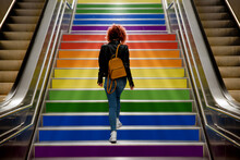 Girl Walking Up The Stairs With The Lgtb Flag On Gay Pride Day.