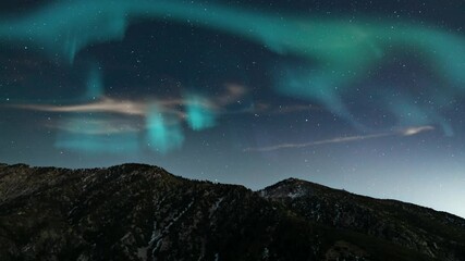 aurora borealis green and purple loop winter mountain peaks northern lights