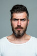 © Volodymyr - Serious man face. Bearded guy. Human expression emotion concept. Portrait of serious man.