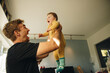 © Jacob Lund - Man playing with his baby boy at home