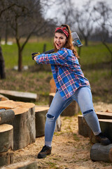 Wall Mural - Strong woman lumberjack splitting logs