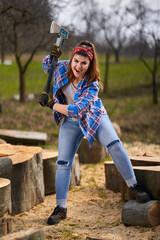 Wall Mural - Strong woman lumberjack splitting logs