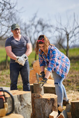 Canvas Print - Husband teaching wife to split logs with an axe