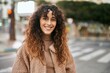 © Krakenimages.com - Young hispanic woman smiling happy standing at the city
