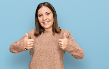 Poster - Young beautiful woman wearing casual clothes success sign doing positive gesture with hand, thumbs up smiling and happy. cheerful expression and winner gesture.