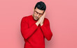 © Krakenimages.com - Handsome hispanic man wearing casual clothes and glasses sleeping tired dreaming and posing with hands together while smiling with closed eyes.
