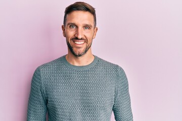 Wall Mural - Handsome man with beard wearing casual winter sweater with a happy and cool smile on face. lucky person.