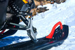 snowmobile ski in the foreground against a blurred mountain winter landscape