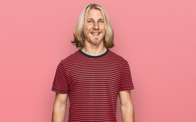 Sticker - Caucasian man with blond long hair wearing casual striped t shirt with a happy and cool smile on face. lucky person.