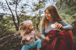 © EVERST - Family lifestyle mother and daughter child outdoor in forest on picnic eating rice cookies travel vacations together with kid