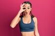 © Krakenimages.com - Young brunette girl wearing sportswear and braids doing ok gesture shocked with surprised face, eye looking through fingers. unbelieving expression.