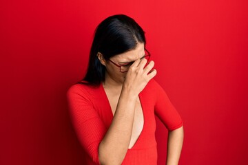 Sticker - Young latin woman wearing casual clothes and glasses tired rubbing nose and eyes feeling fatigue and headache. stress and frustration concept.