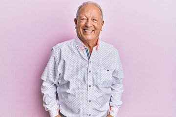 Senior caucasian man wearing casual clothes with a happy and cool smile on face. lucky person.