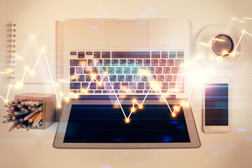 Stock market chart and top view computer on the table background. Multi exposure. Concept of financial analysis.