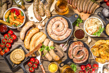 Wall Mural - Assortment of different fried sausages. Set with various meat Bavarian, Frankfurt, German grilled sausages, Oktoberfest or summer BBQ party concept, old wooden background copy space top view