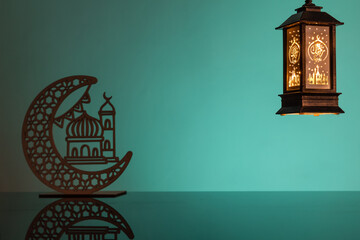 Wall Mural - Eid Mubarak concepts with lamp inscribed with arabic text translated to english as Ramadhan is our light., with crescent moon in silhouette