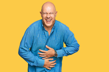 Wall Mural - Middle age bald man wearing casual clothes smiling and laughing hard out loud because funny crazy joke with hands on body.