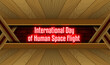 April month special day. International Day of Human Space Flight, Neon Text Effect on Bricks Background