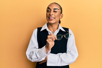 Hispanic man wearing make up and long hair wearing business shirt and glasses winking looking at the camera with sexy expression, cheerful and happy face.