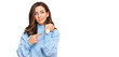 © Krakenimages.com - Young brunette woman wearing casual winter sweater in hurry pointing to watch time, impatience, looking at the camera with relaxed expression