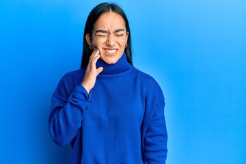 Canvas Print - Young asian woman wearing casual winter sweater touching mouth with hand with painful expression because of toothache or dental illness on teeth. dentist