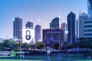Panoramic view skyscrapers. Modern cityscape of the capital of the Emirate of Dubai. Financial services hub. Information security concept. Lock icon. Double exposure.