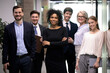 © fizkes - Portrait of happy multiethnic diverse employees colleagues pose together in office. Confident young successful African American businesswoman or team leader with staff show unity and leadership.