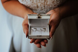 Fototapeta  - the bride holds in her hands a box with wedding rings
