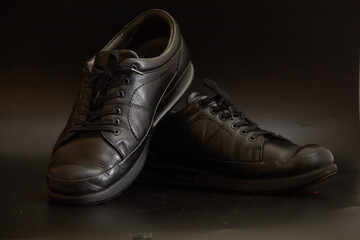 Black men's shoes on a black background