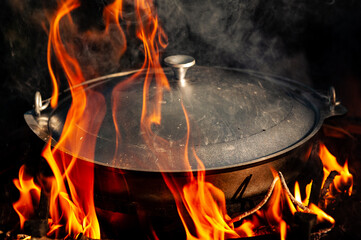 Outdoor cooking with a cast iron pot on a open fire