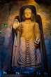 © pornpun - Large stone statue of Buddha in a cave in Wat Saket Golden Mountain Temple famous Landmark in Bangkok, Thailand.
