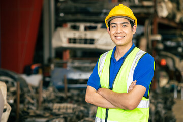 confident Asian male engineer worker standing arm crossed happy smile for enjoy working in factory