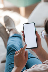 woman hold mobile phone in hands, lying on sofa