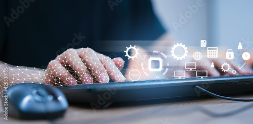 Obraz Dibond close up on robot hand working on laptop to checking correct data by using RPA function software program to help proof and detect and synchronize to system for future technology of business concept