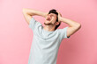 Young Russian man isolated on pink background stressed overwhelmed
