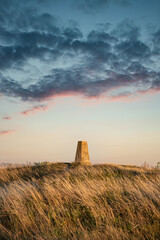 Wall Mural - Stunning Summer sunset landscape image of trig point in South Downs National Park in English countryisde