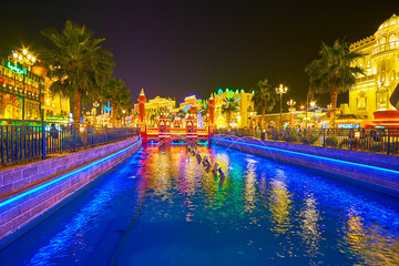 Canvas Print - Enjoy the colored fountains on canal in Global Village in Dubai, UAE