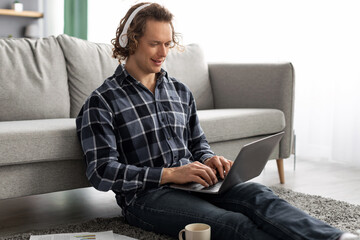 Poster - Man In Headphones Using Laptop Working Online Sitting At Home