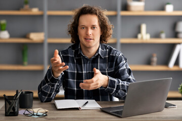 Poster - Businessman At Laptop Talking Looking At Camera Sitting In Office