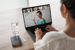 © shellygraphy - remote online working woman sitting on a work desk with laptop in in her home office joining an online meeting or watching video conference or webinar presentation