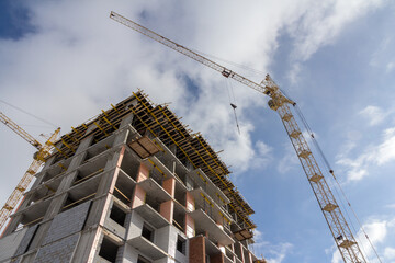 Poster - Reinforced concrete construction. Construction yellow crane and building construction. Modern construction technologies