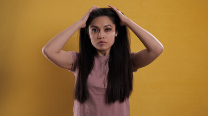 Wall Mural - Portrait of a young beautiful woman against a neutral background - studio photography