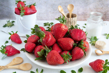 Wall Mural - Close-up of fresh, ripe, red strawberries on a plate on a table